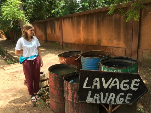 Blythe observing the wash facilities in  Ouagadougou.