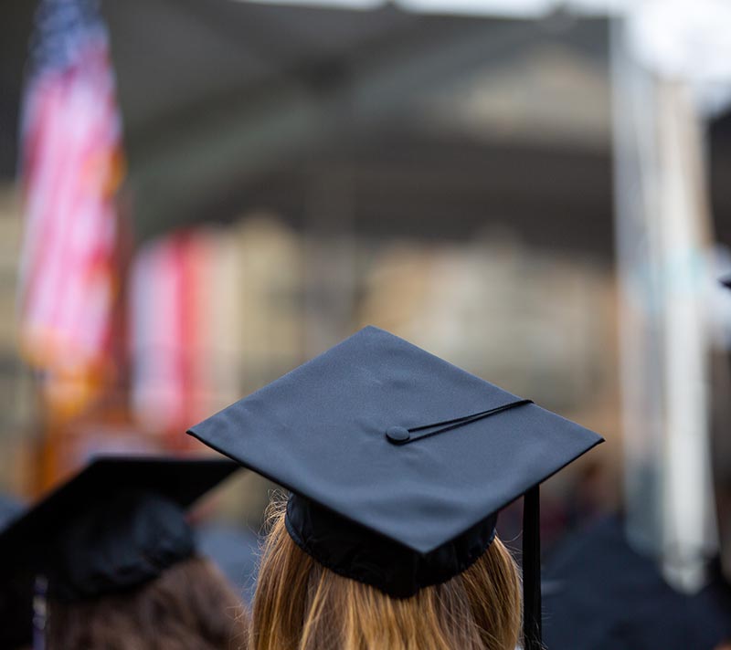 Person in Graduation hat facing away from the camera