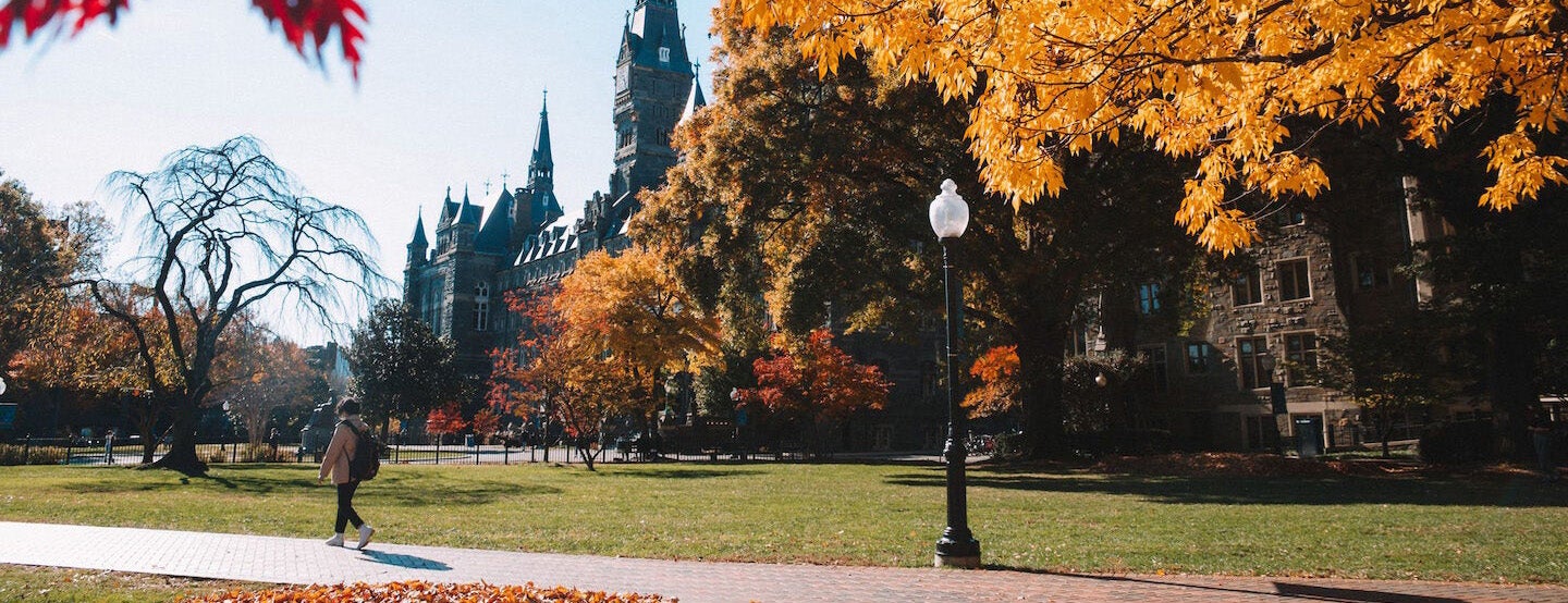 student walking in front of Healy Hall